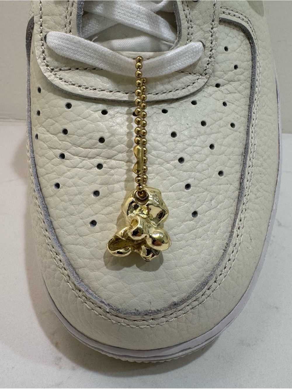 Men’s White Athletic Sneaker with Gold Charm Accent
